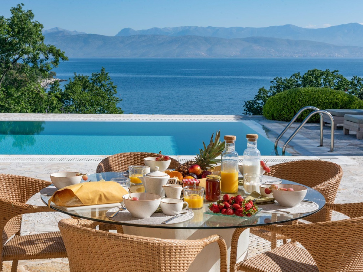 Pool with outdoor dining at Villa Anthi