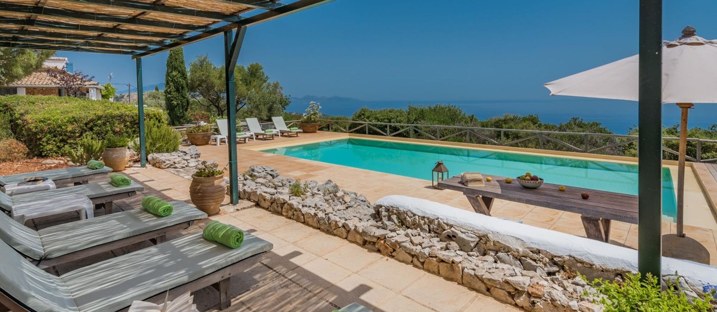 Pool with sun loungers and terrace at Villa Ariane