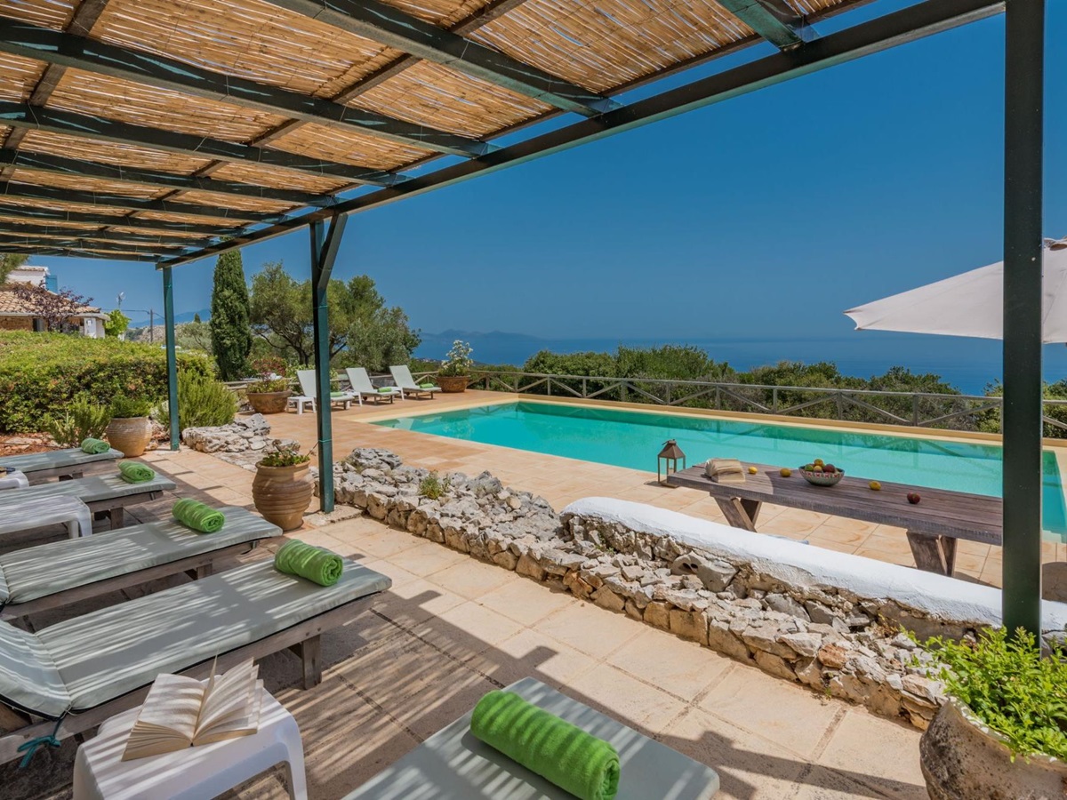 Pool with sun loungers and terrace at Villa Ariane