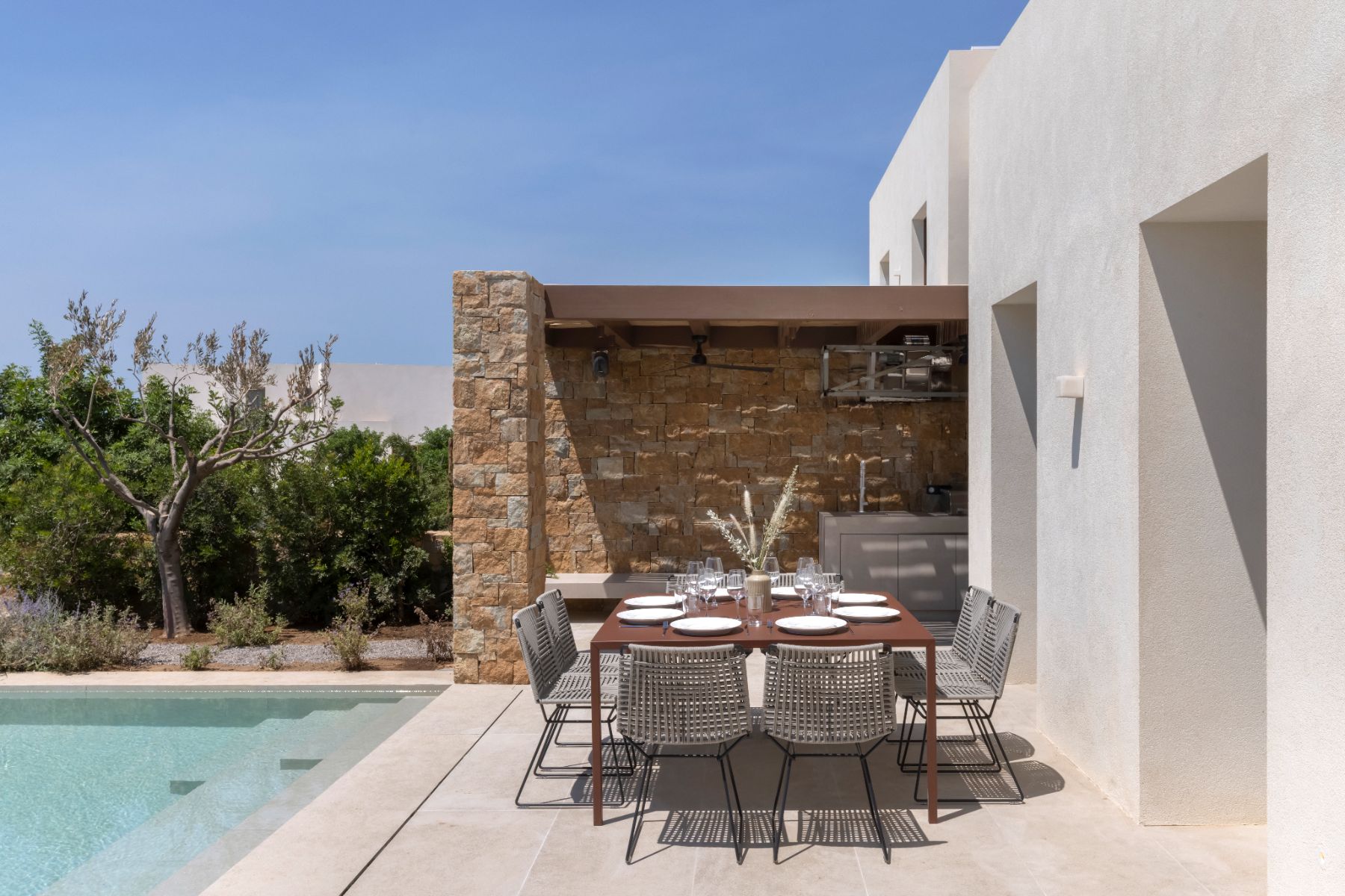 Outdoor dining terrace by the pool at Villa Astra, Paros