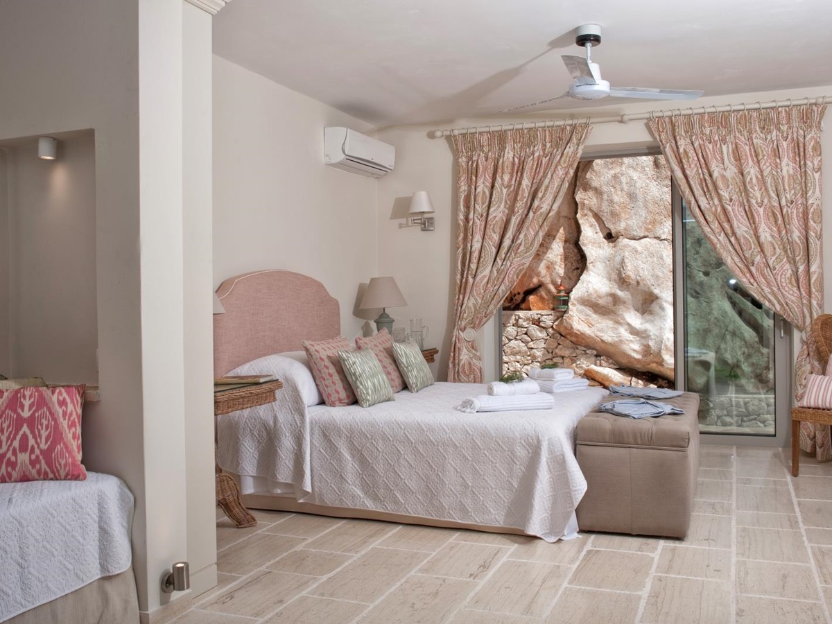 Double bedroom with pink furnishings at Villa Dionysos, Corfu