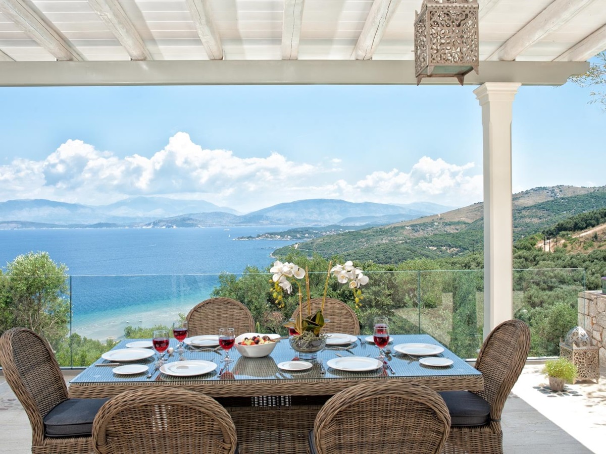 Outdoor dining table set for lunch with view towards the sea at Villa Dionysos, Corfu