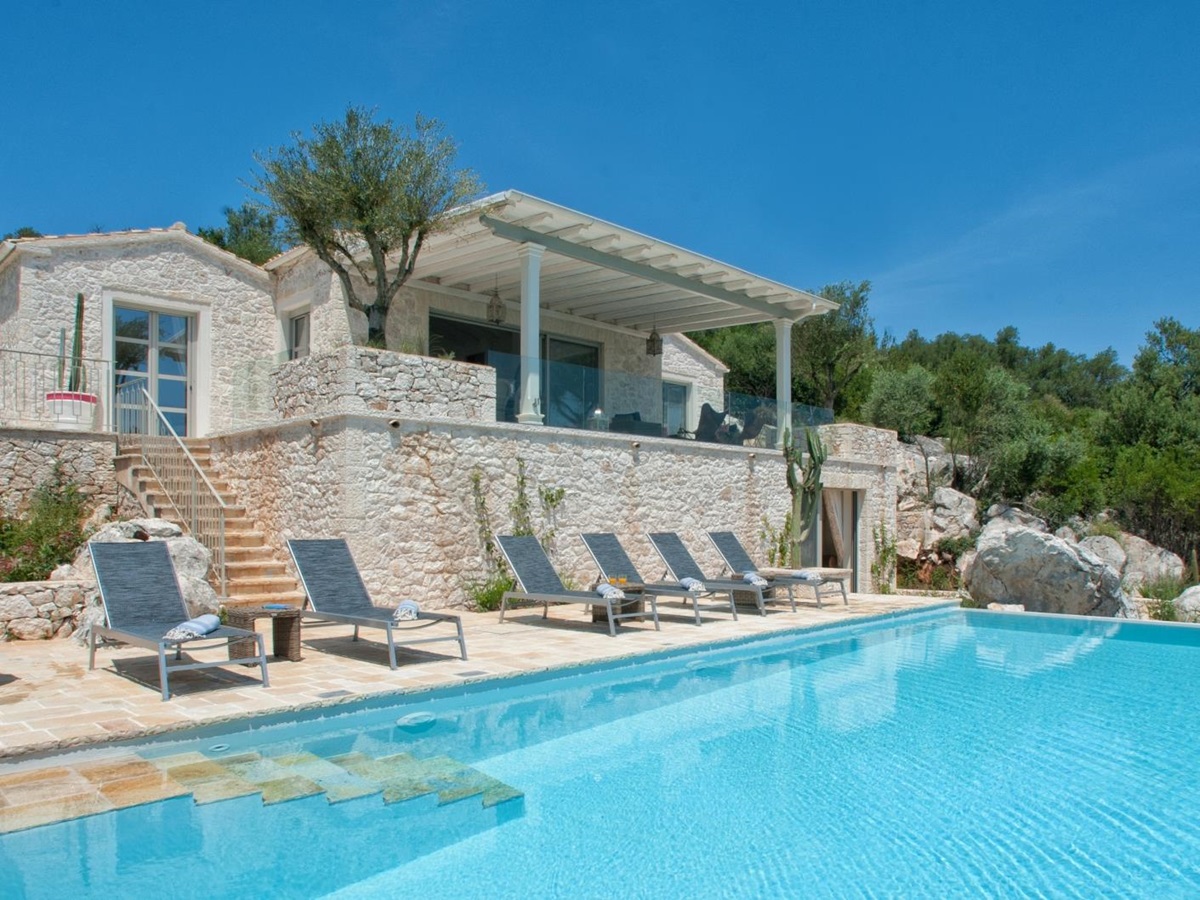 Exterior of villa with pool and loungers at Villa Dionysos, Corfu