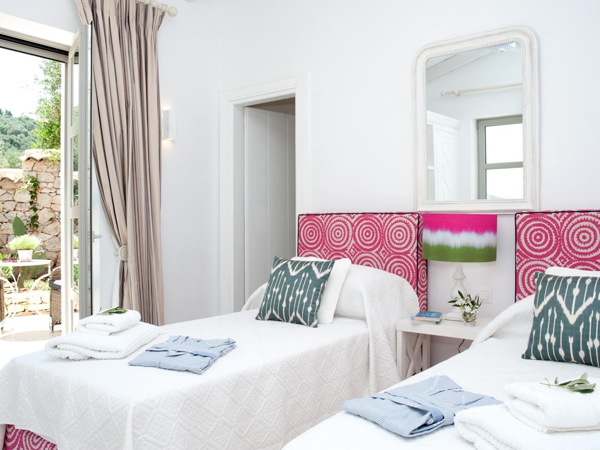 Twin bedroom with pink headboards at Villa Dionysos, Corfu