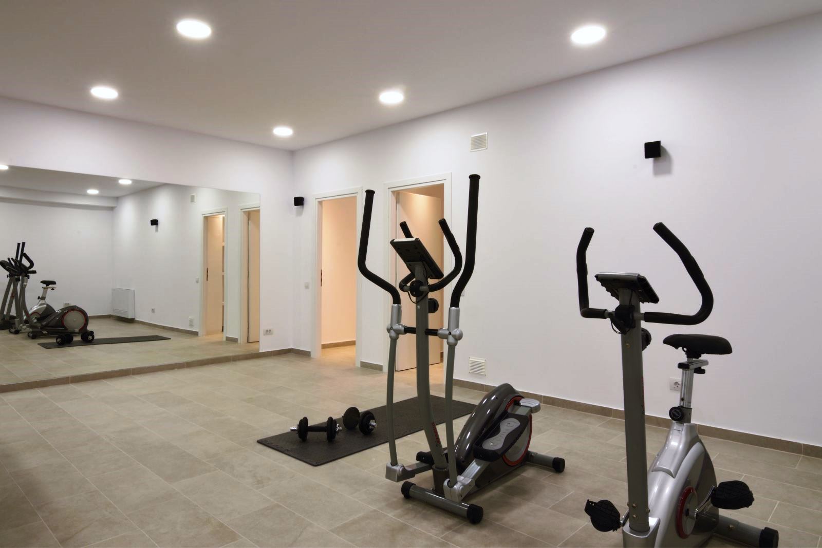 Gym equipment in room with big mirror at villa eleni in corfu, Greece