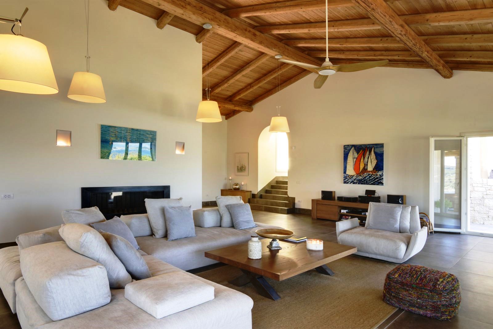 Seating area with white sofas and ceiling fan at villa eleni in corfu, Greece