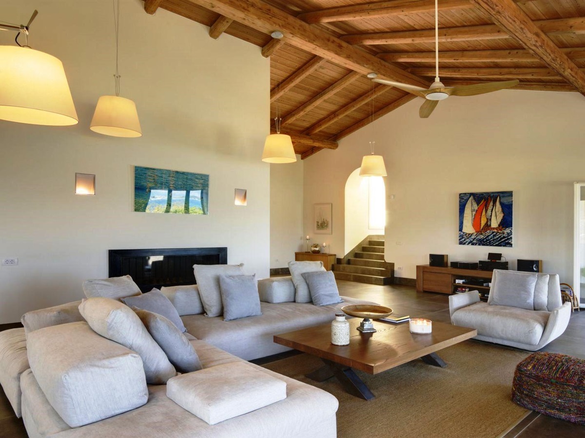 Seating area with white sofas and ceiling fan at villa eleni in corfu, Greece