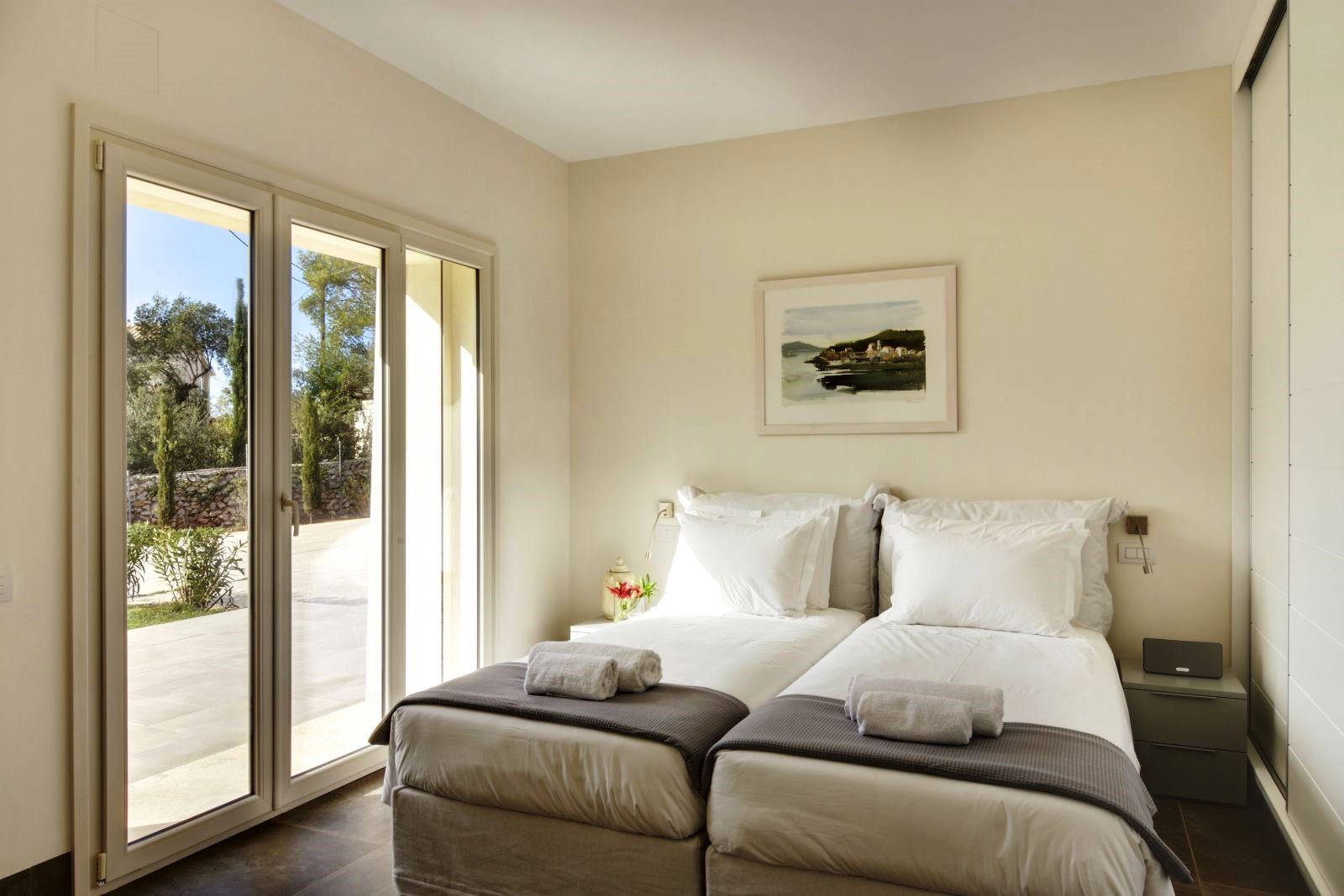 Twin bedroom with doors out onto sun terrace at villa eleni in corfu, Greece