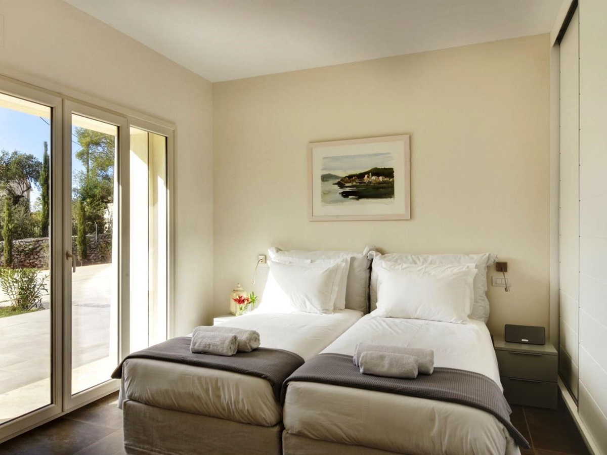 Twin bedroom with doors out onto sun terrace at villa eleni in corfu, Greece