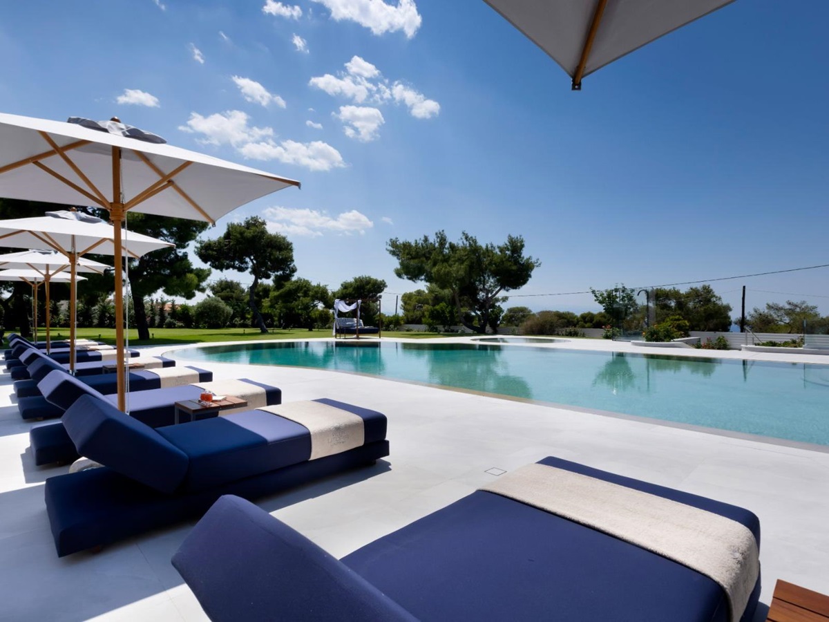 Pool with sun loungers at Villa Elysian