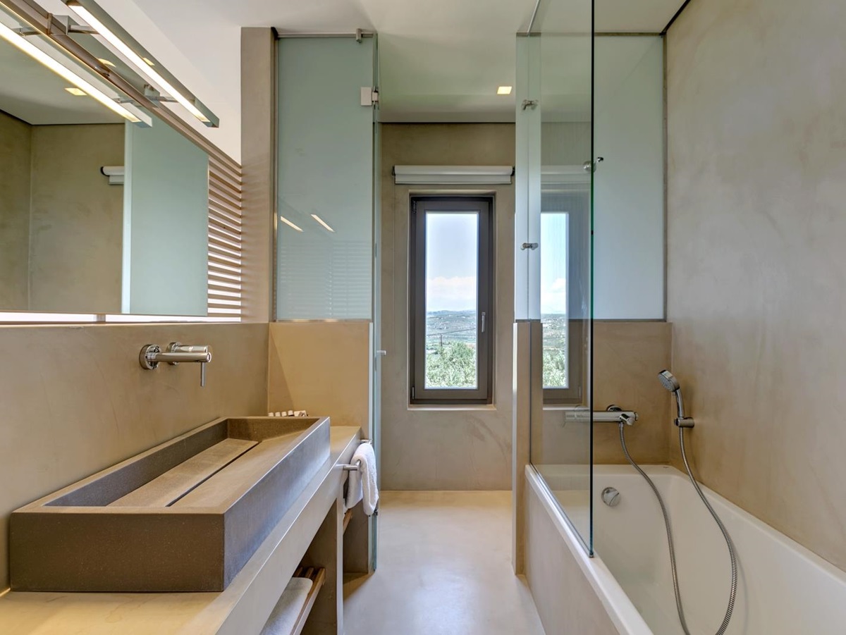 Bathroom with long sink, long mirror, bath and long window at Villa Ianira on Crete, Greece
