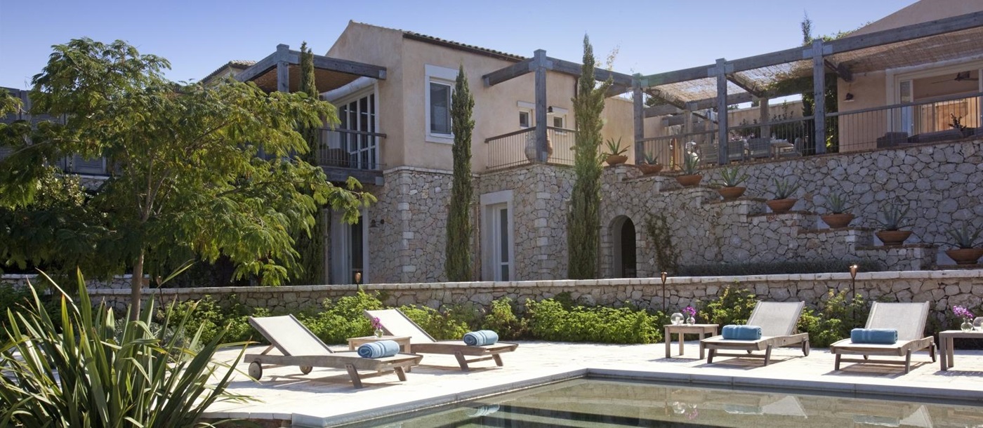 Pool, sun loungers and view of terrace at Villa Icarius on Corfu, Greece