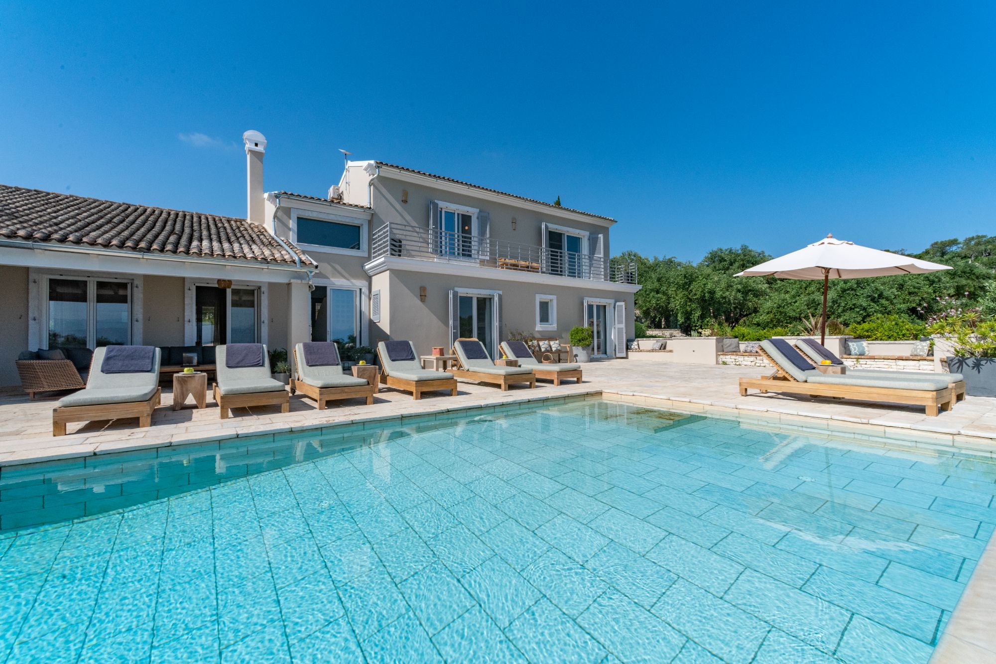 Pool with loungers at Villa Ioulia