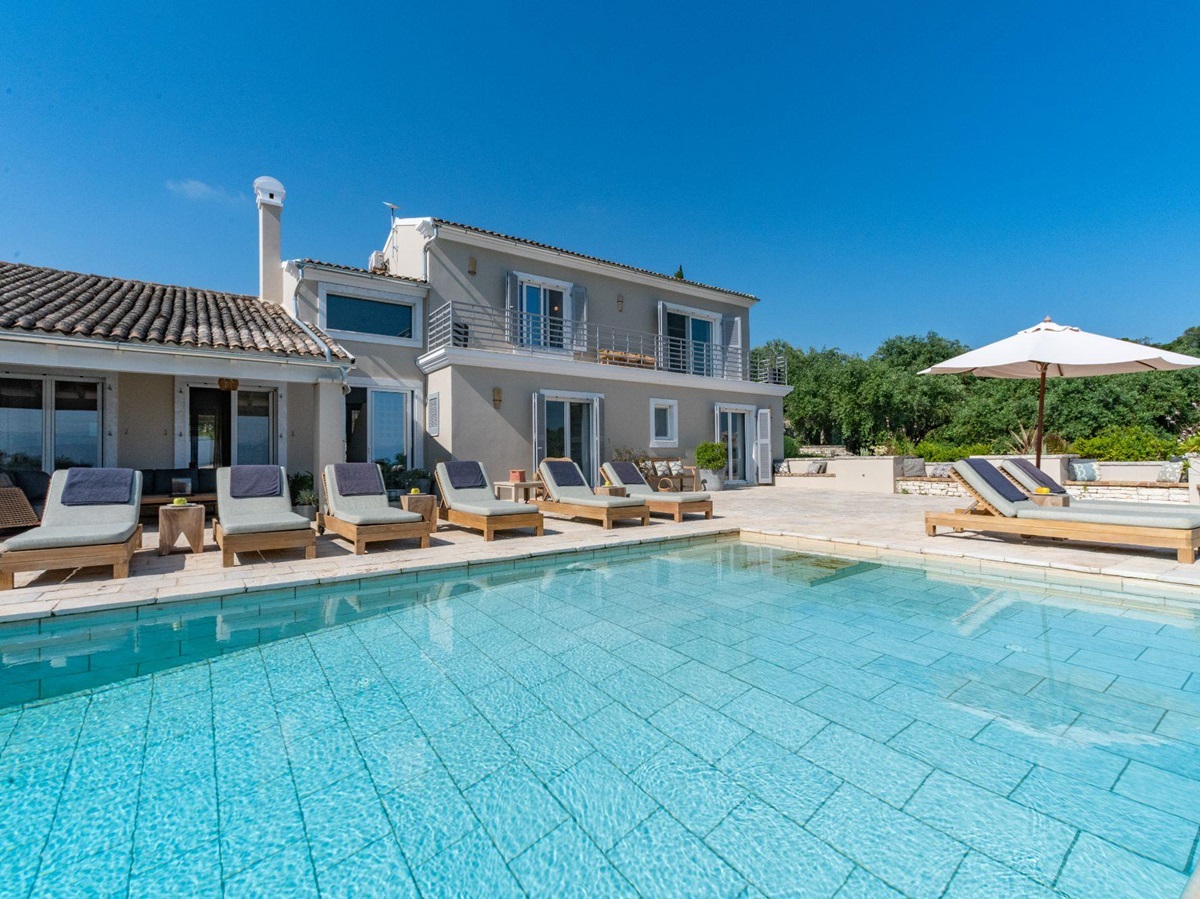 Pool with loungers at Villa Ioulia