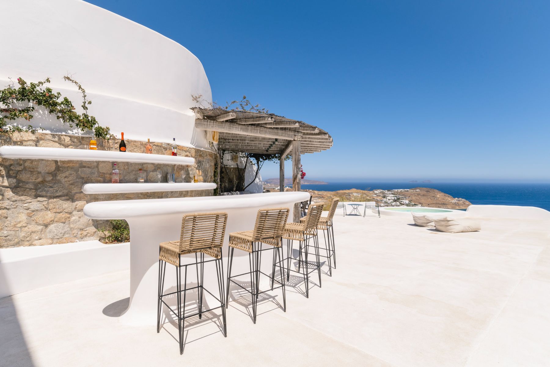 Outdoor bar with seating and sea view at Villa Kallos, Mykonos