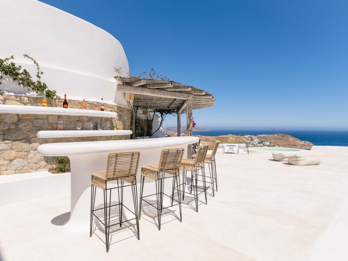 Outdoor bar with seating and sea view at Villa Kallos, Mykonos