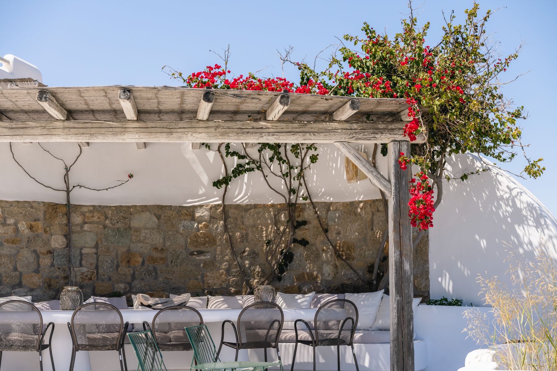 Covered terrace with dining table at Villa Kallos, Mykonos