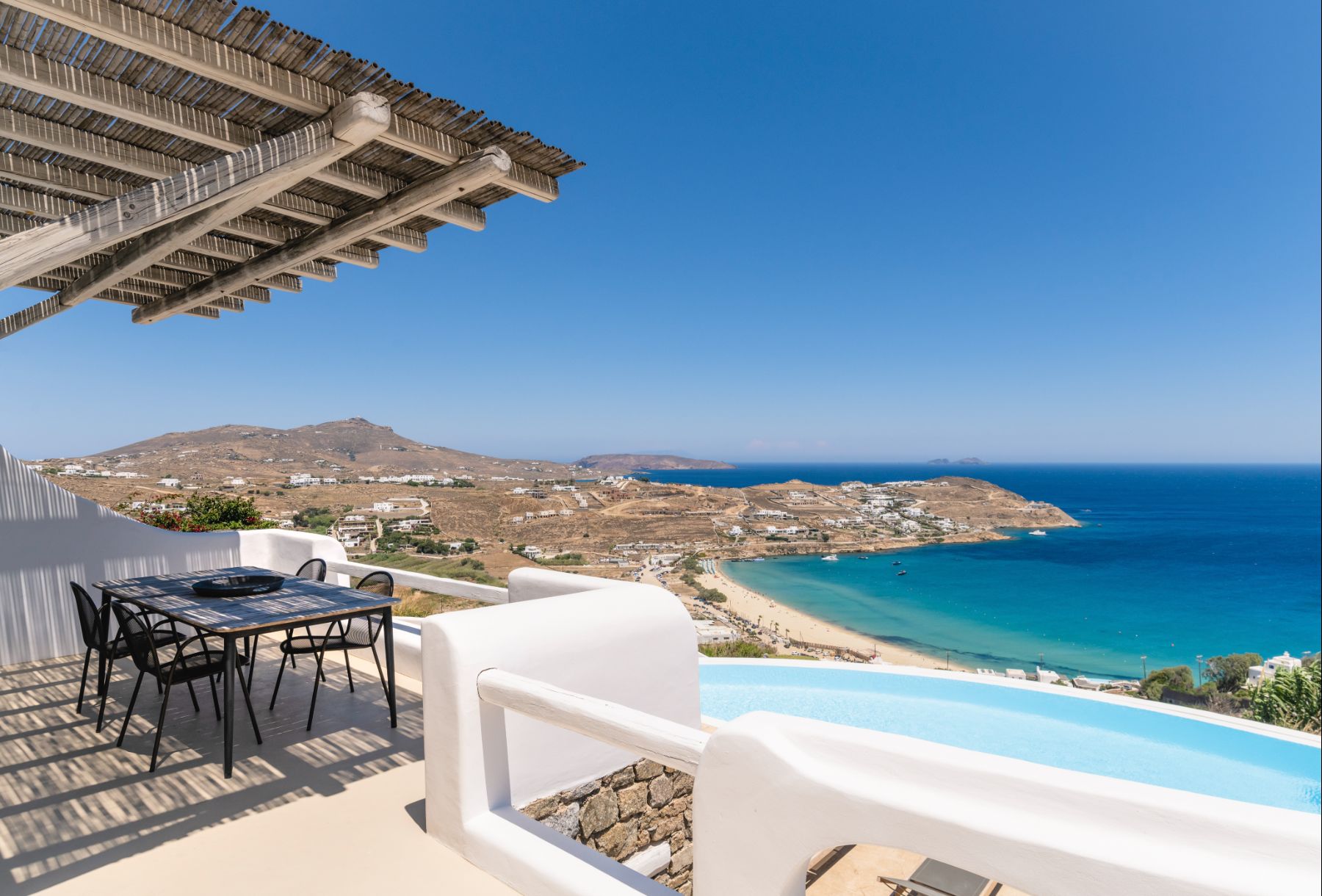 Outdoor dining area with sea views at Villa Kallos, Mykonos
