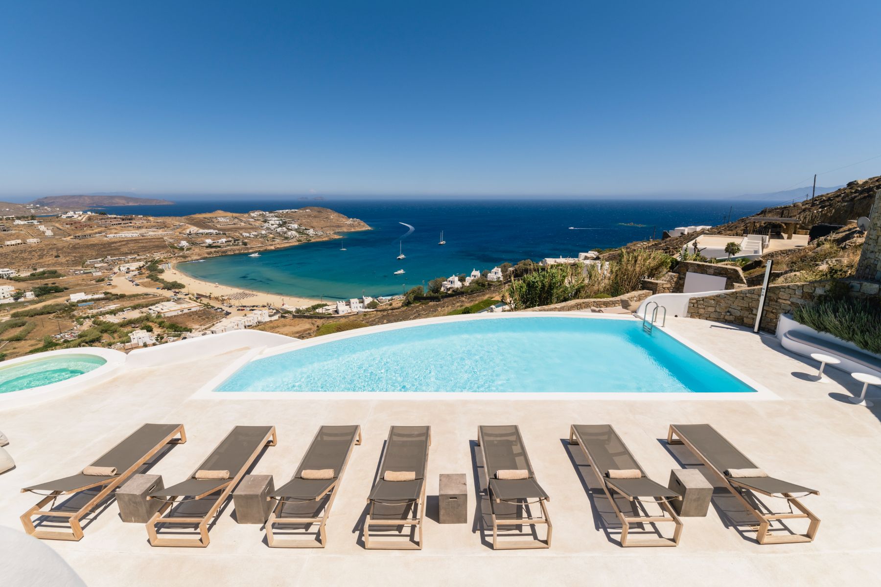 Pool and sun loungers with sea view at Villa Kallos, Mykonos