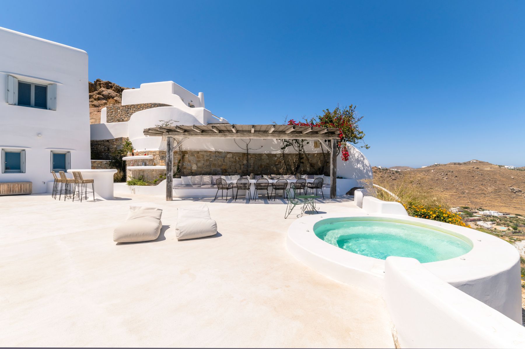 Terrace with hot tub and dining area at Villa Kallos, Mykonos