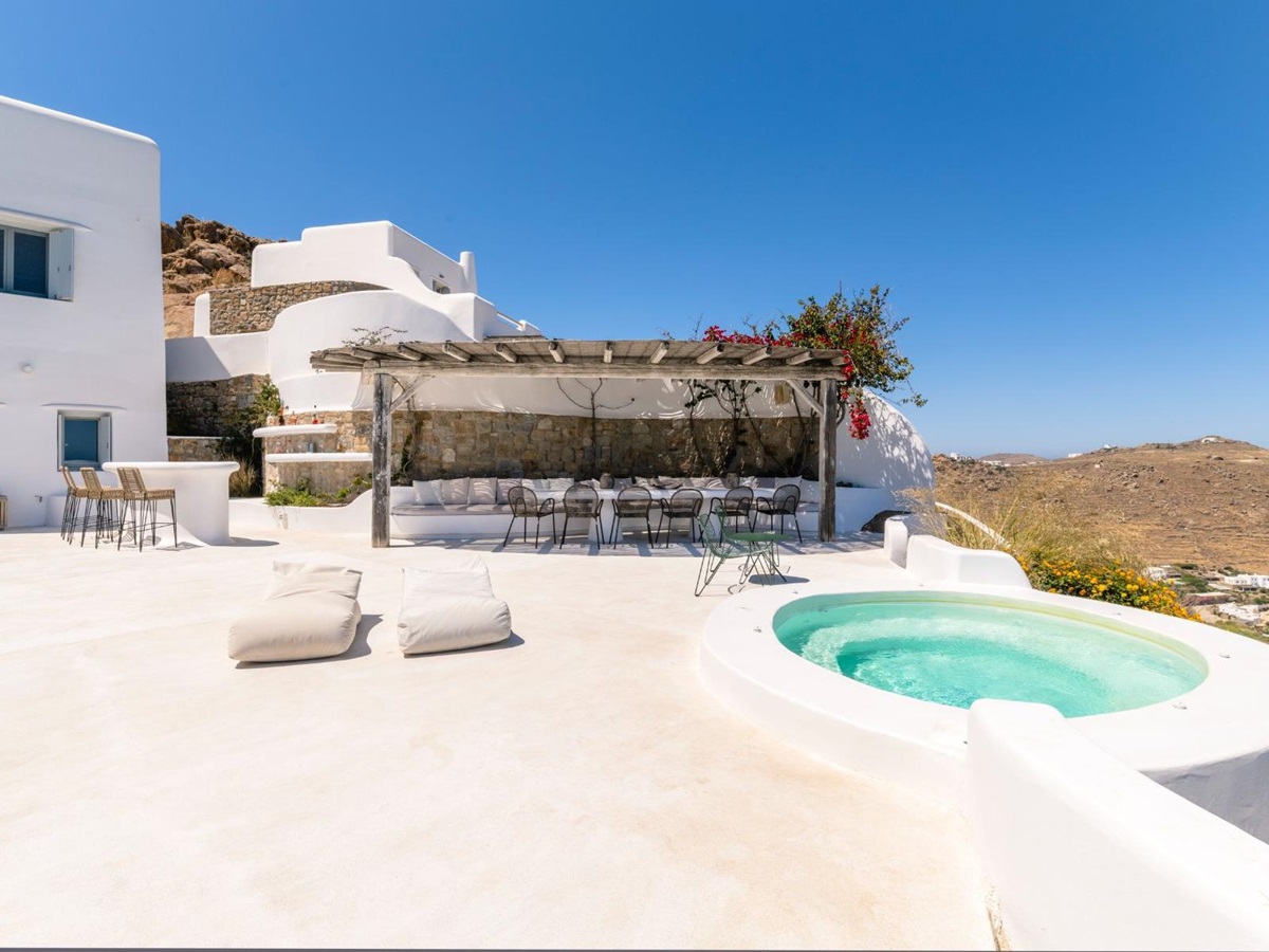 Terrace with hot tub and dining area at Villa Kallos, Mykonos