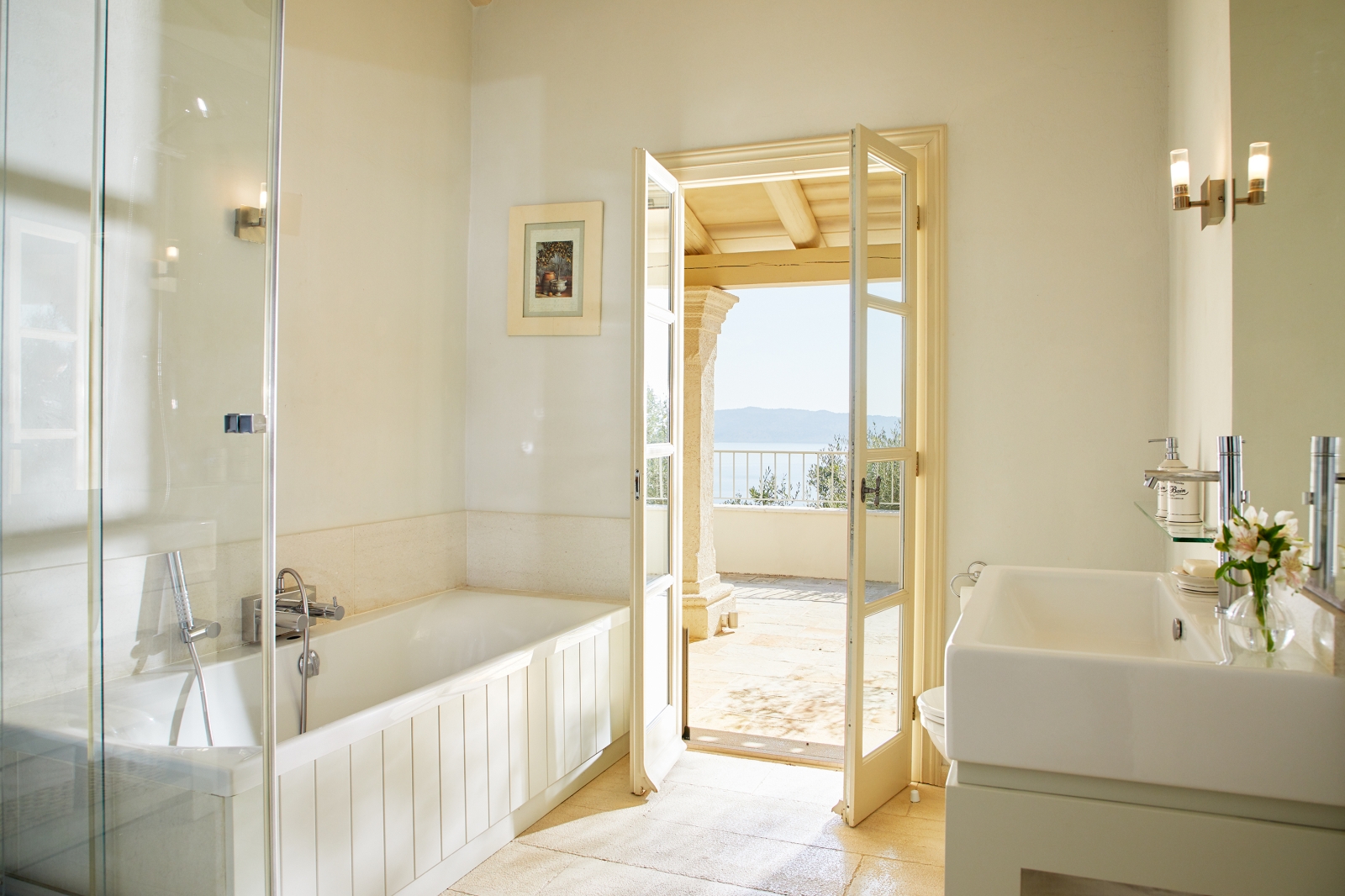 Bathroom with shower and door to terrace at Villa Kerasia in Corfu