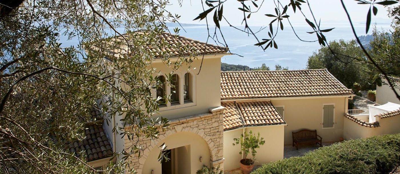 Stone exterior of property with sea view at Villa Kerasia in Corfu