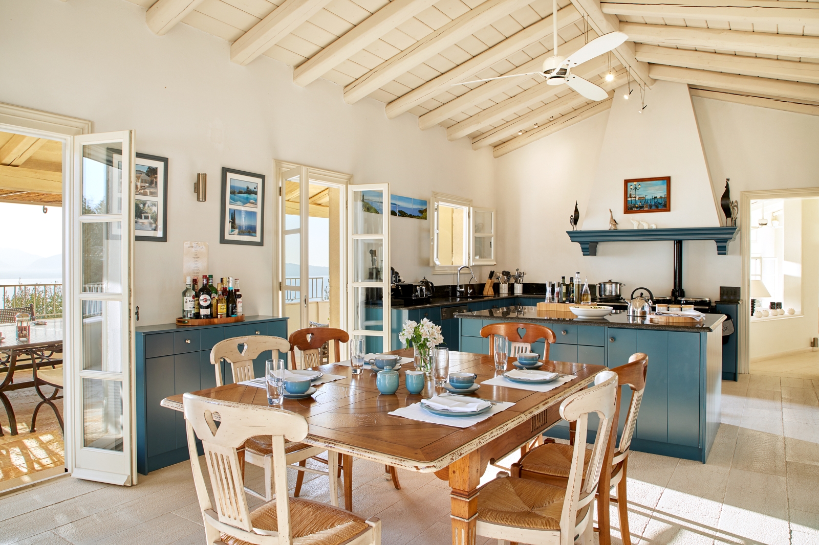 Kitchen with dining table and blue surfaces at Villa Kerasia in Corfu