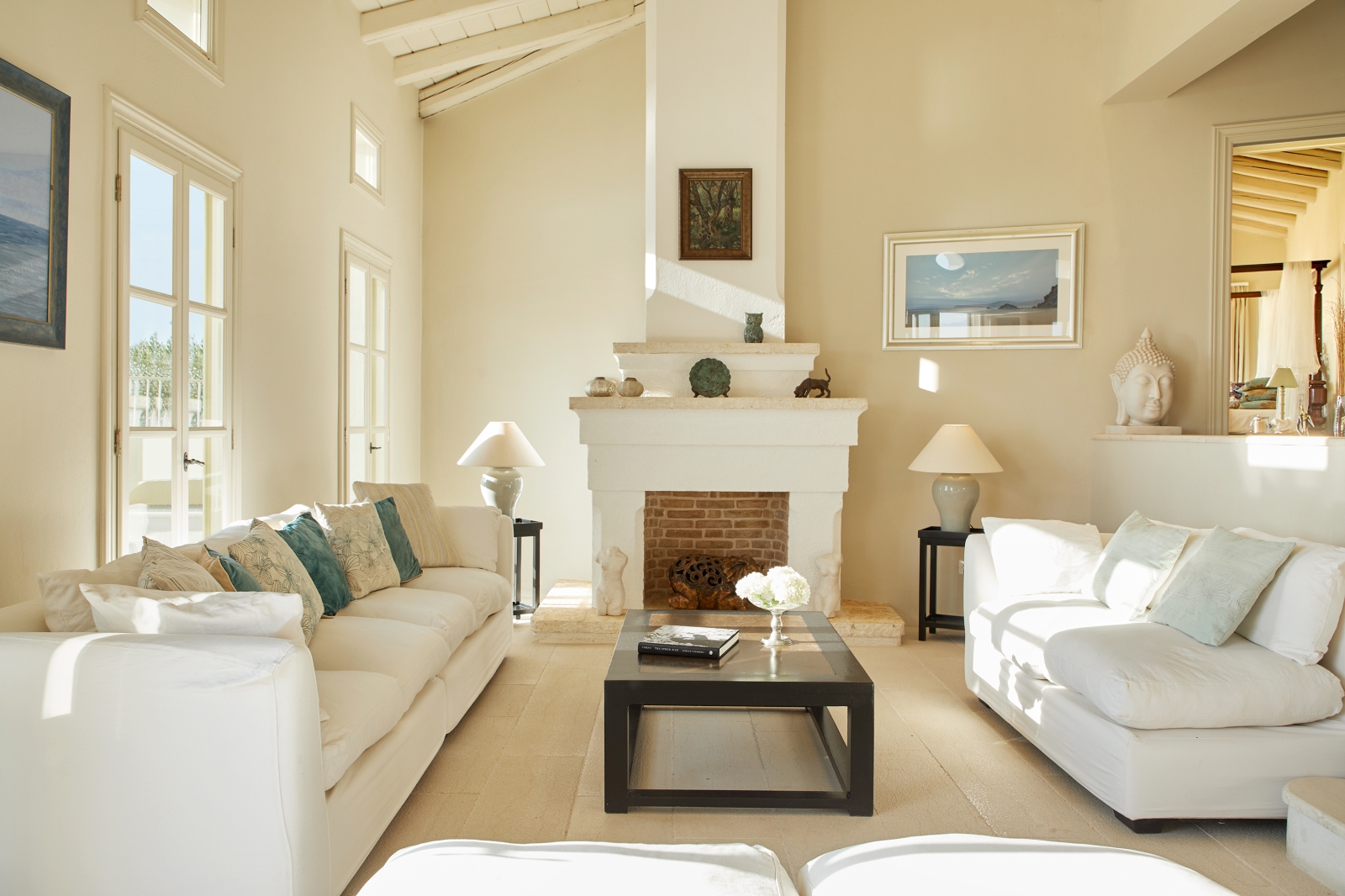 Living room with white sofas and fireplace at Villa Kerasia in Corfu
