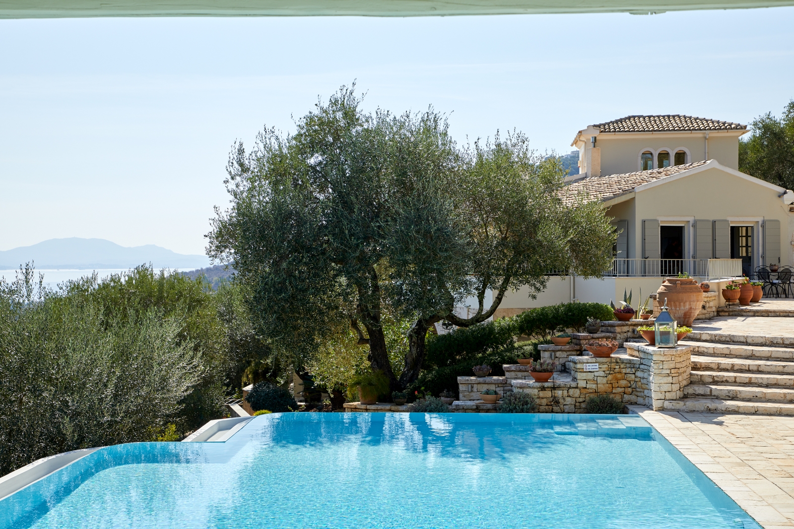 Pool with villa in the background at Villa Kerasia in Corfu