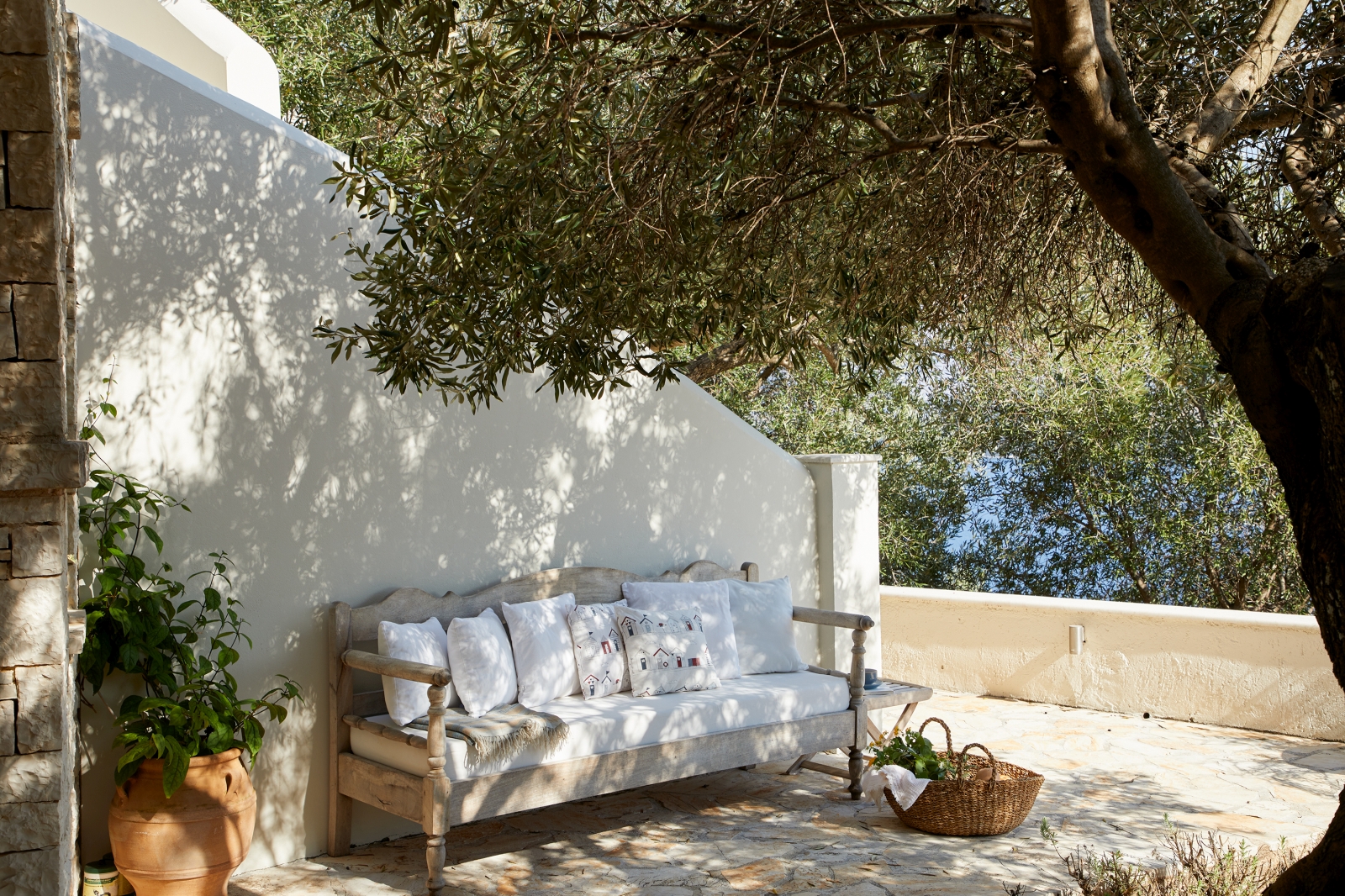 Outdoor seating with dappled shade at Villa Kerasia in Corfu