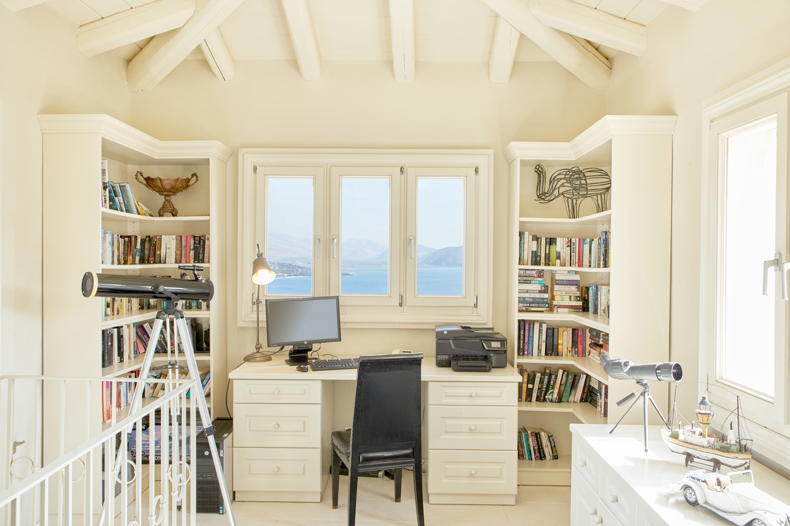 Study with bookshelves and large windows at Villa Kerasia in Corfu