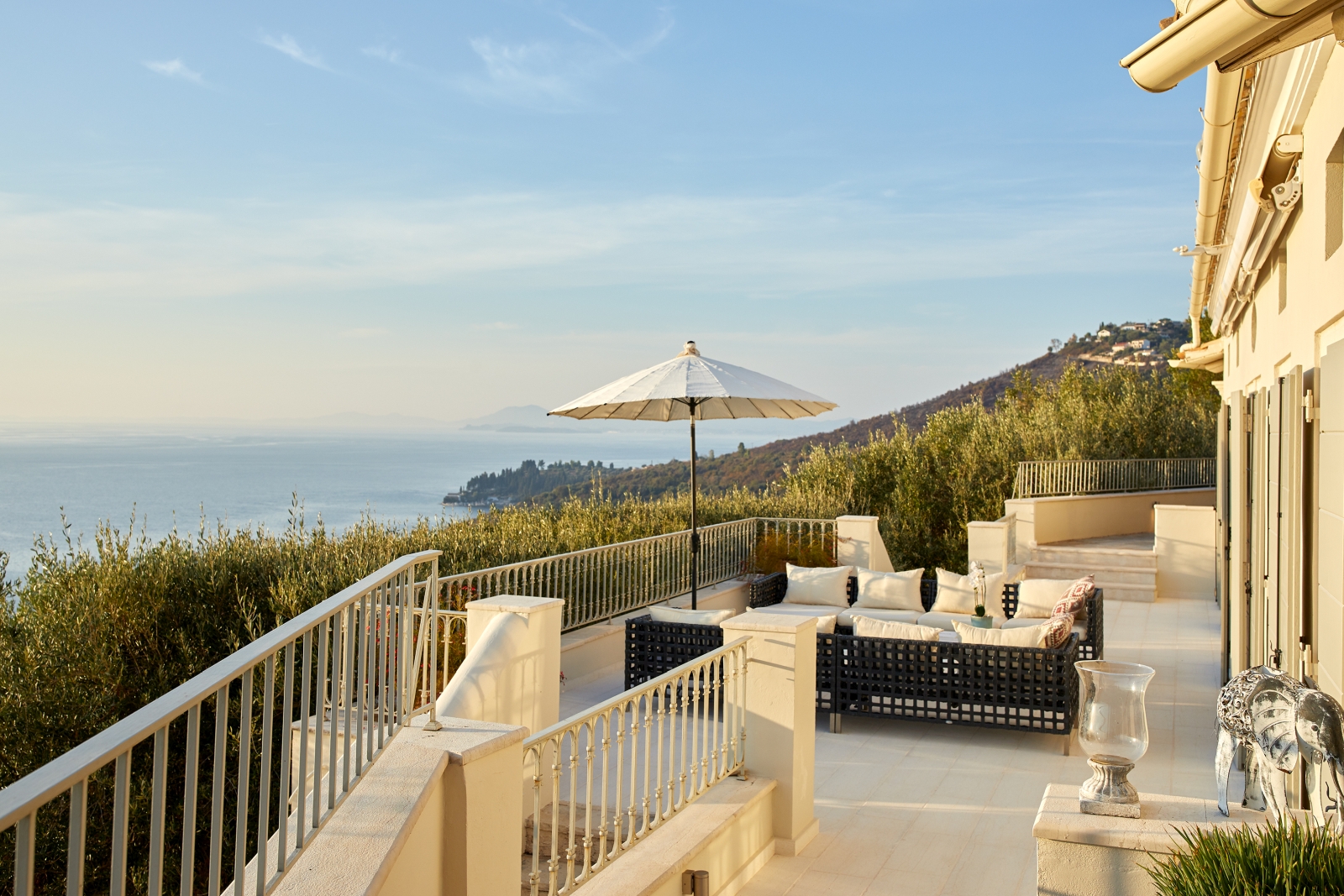 Terrace with seating and view at sunset at Villa Kerasia in Corfu