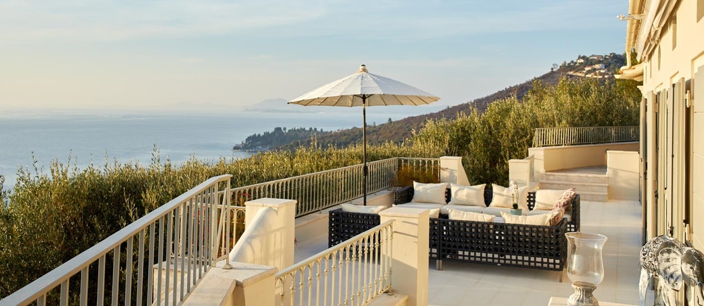 Terrace with seating and view at sunset at Villa Kerasia in Corfu