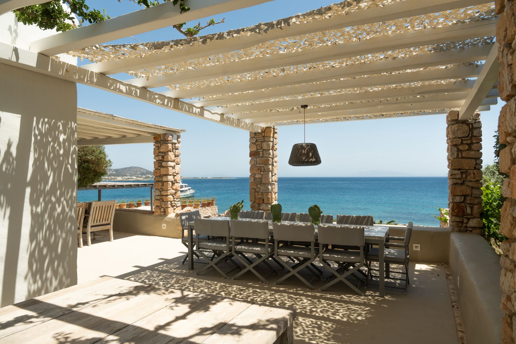 Outdoor dining terrace with sea view at Villa Kymata, Paros