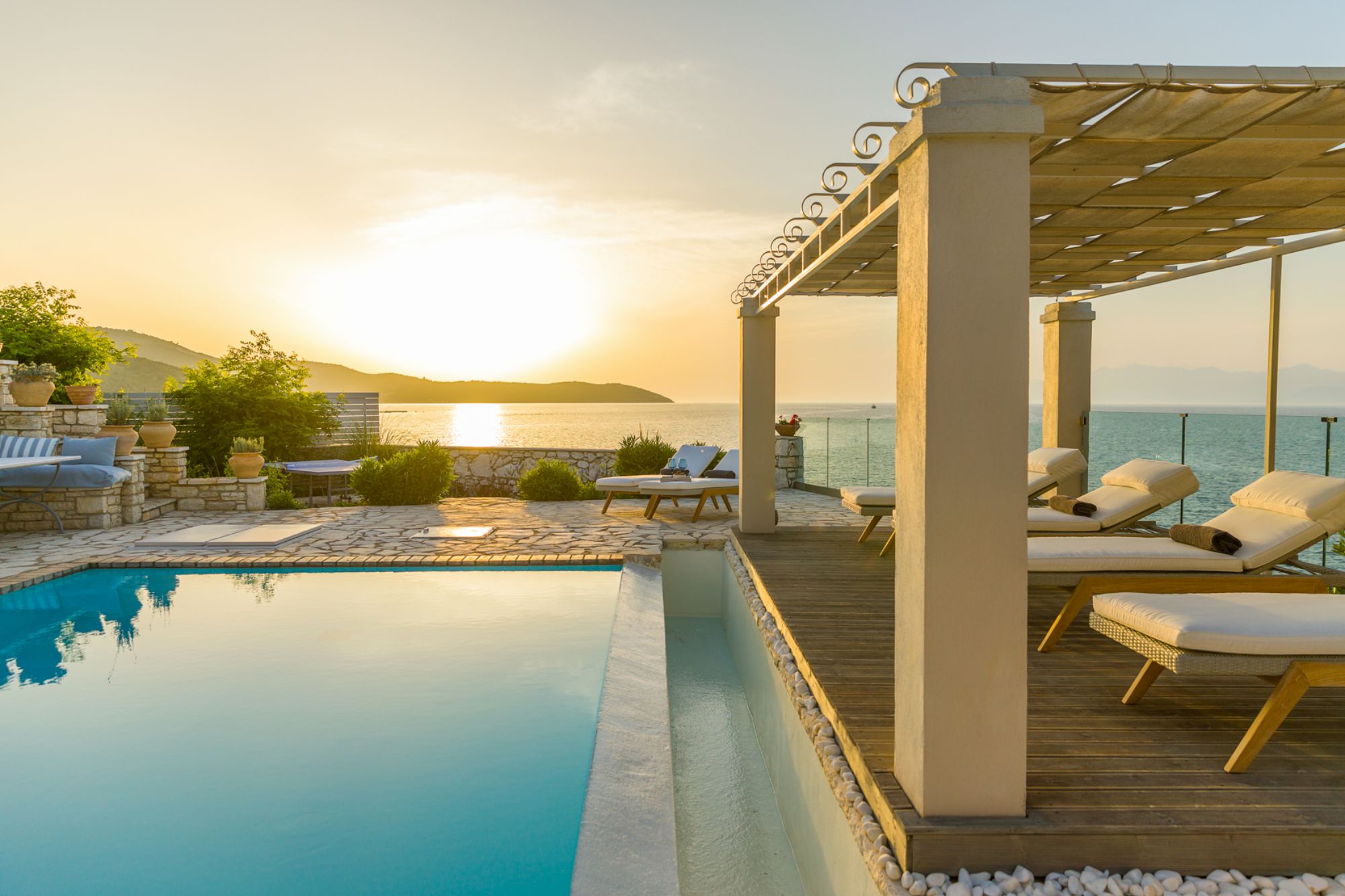Pool and sunloungers in the evening at Villa Laura