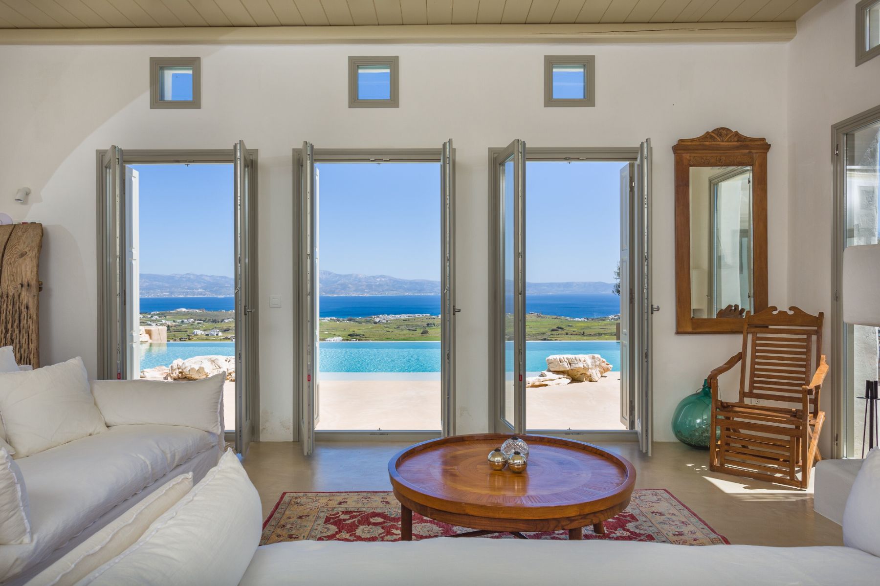 Living room with views of the pool and sea at Villa Livadi, Paros