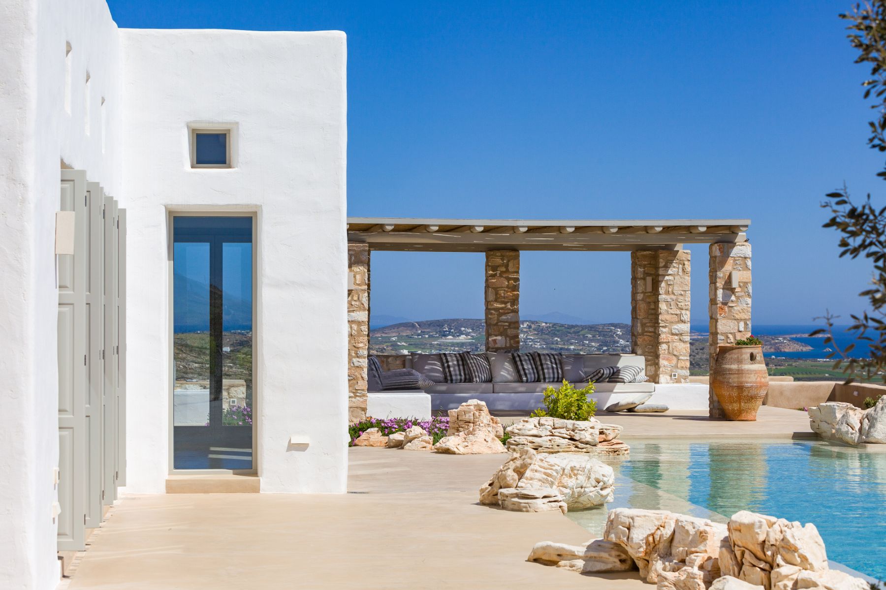 Pool with covered seating area at Villa Livadi, Paros