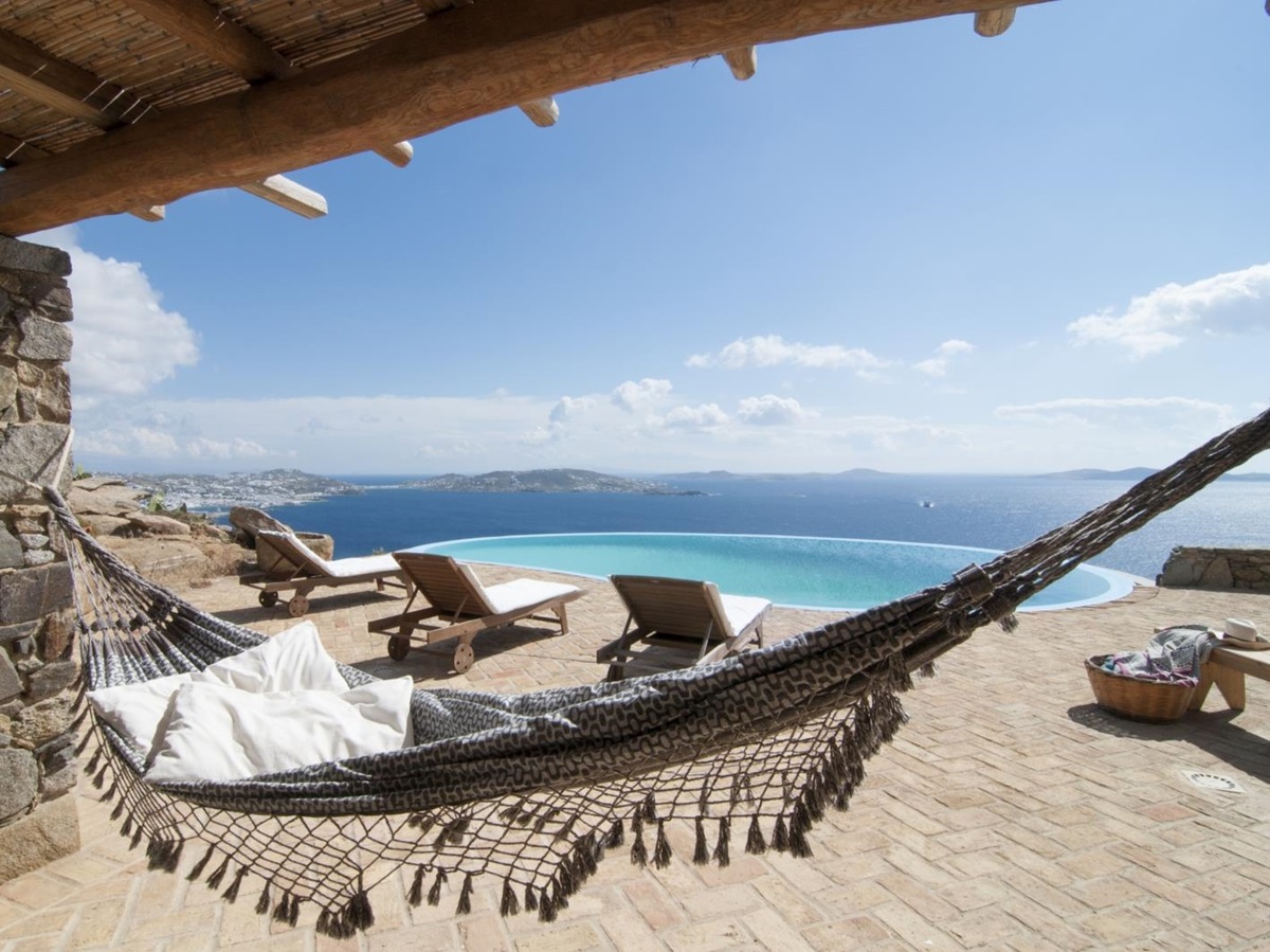 Hammock and terrace with sun loungers, infinity pool and sea view at Villa Mari on Mykonos, Greece
