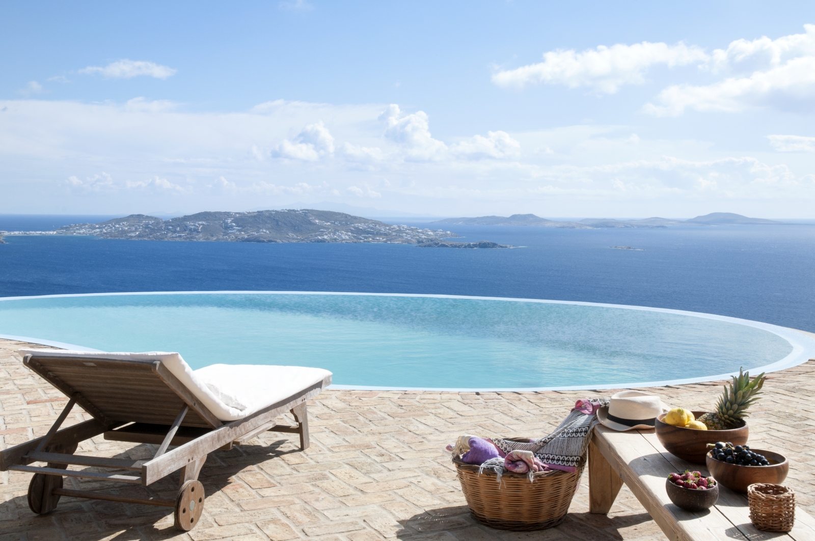 Terrace with infinity pool, sun lounger, fresh fruit and sea view at Villa Mari on Mykonos, Greece