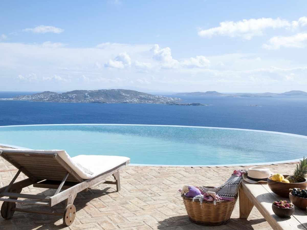 Terrace with infinity pool, sun lounger, fresh fruit and sea view at Villa Mari on Mykonos, Greece