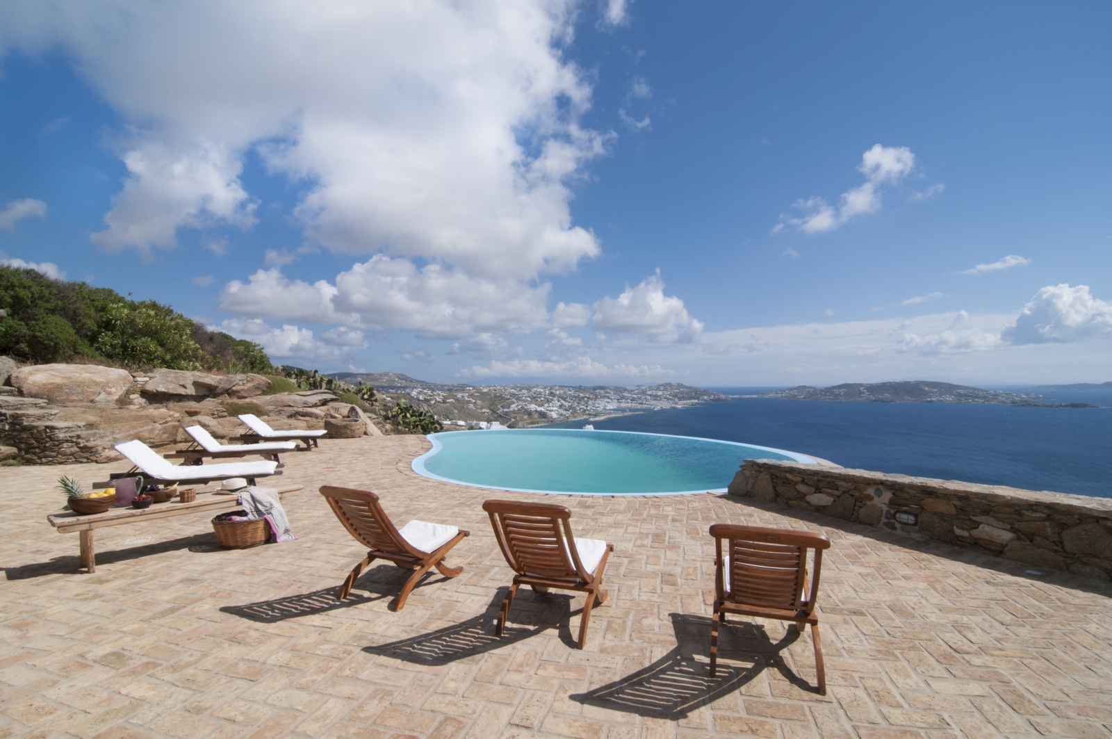 Terrace with sun loungers, coffee table, infinity pool and sea view at Villa Mari on Mykonos, Greece