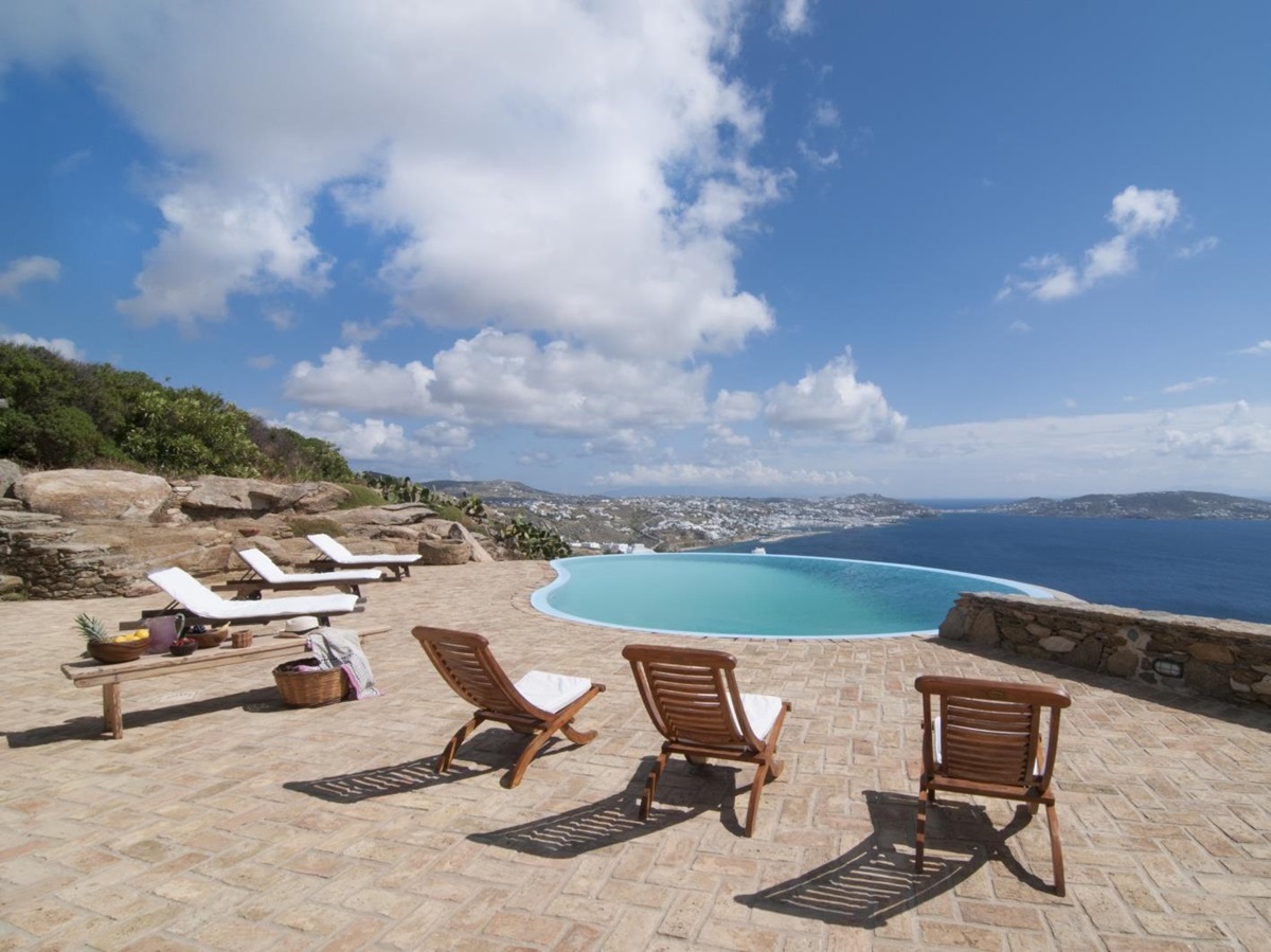 Terrace with sun loungers, coffee table, infinity pool and sea view at Villa Mari on Mykonos, Greece