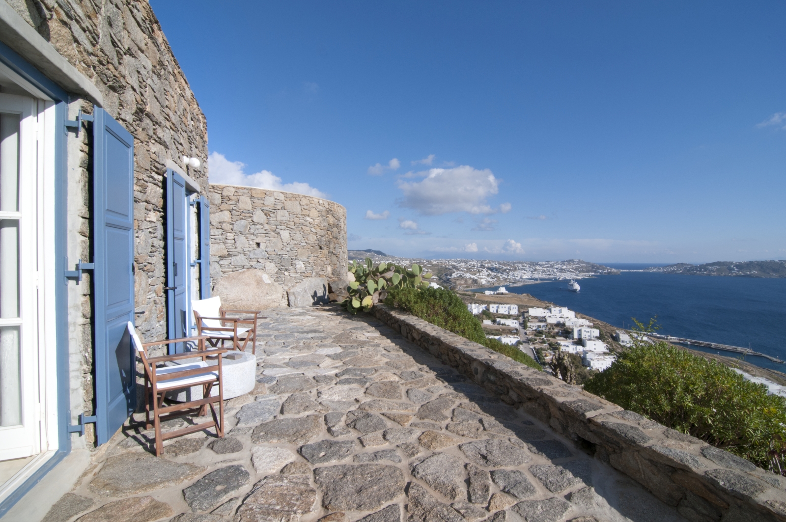 Private terrace with chairs, table and sea view at Villa Mari on Mykonos, Greece