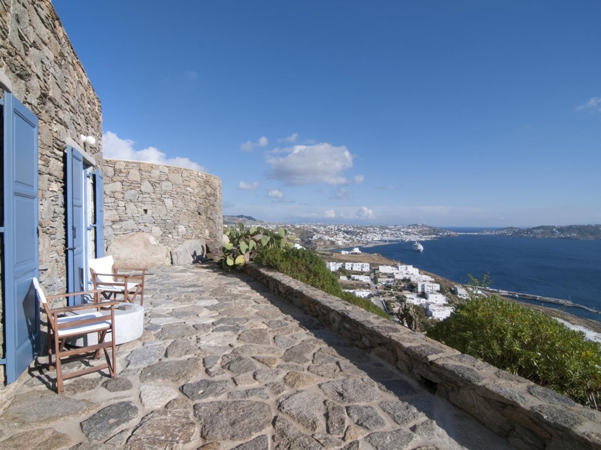 Private terrace with chairs, table and sea view at Villa Mari on Mykonos, Greece
