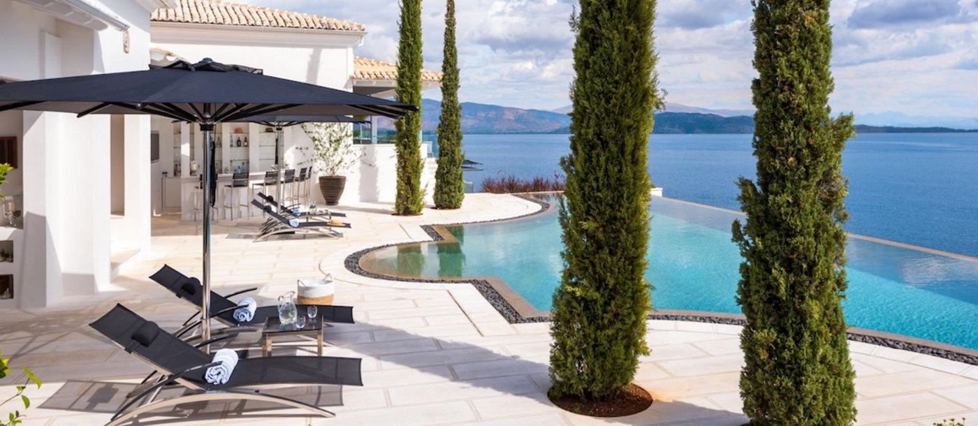 Pool and sun loungers at Villa Nissaki