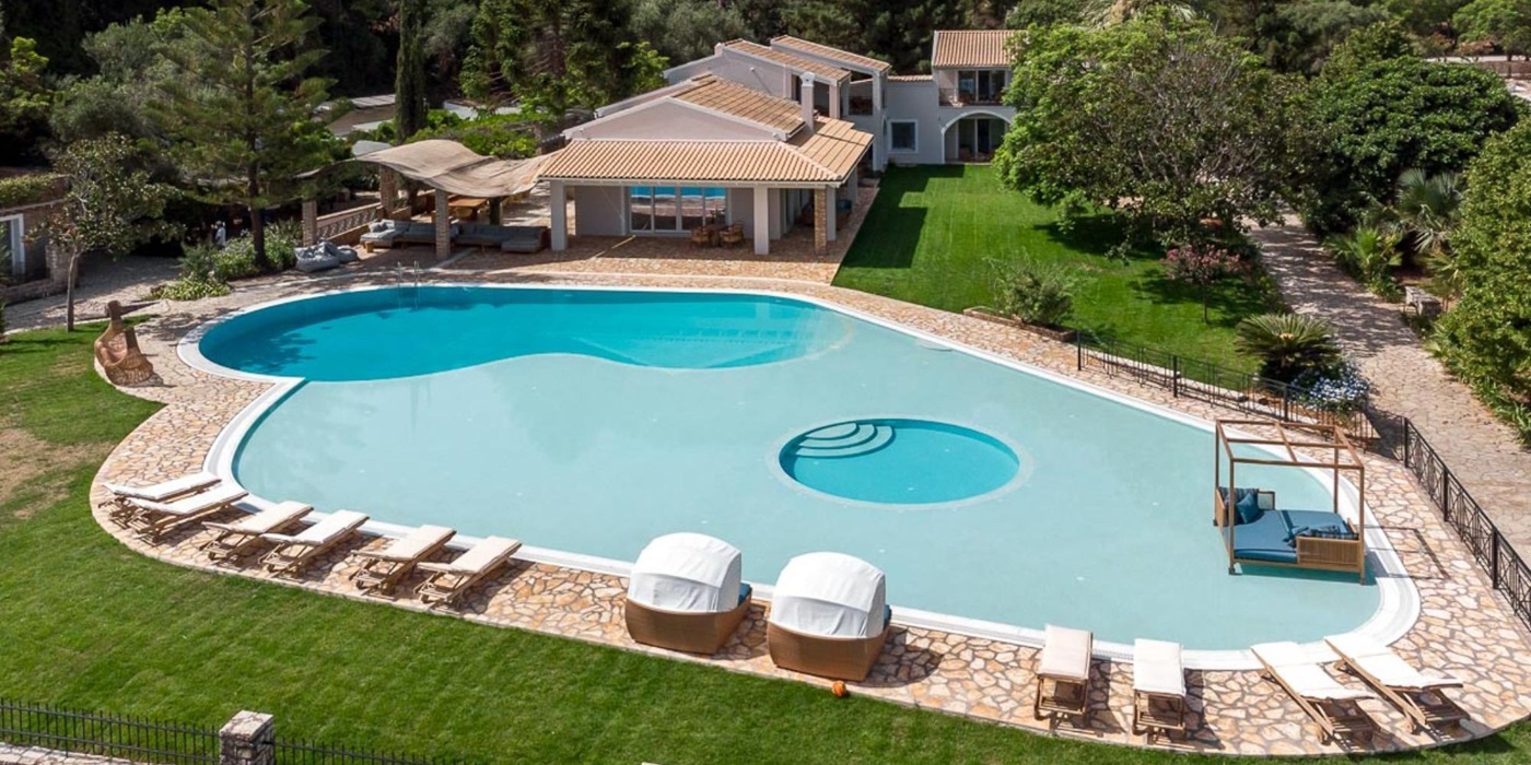 Pool area with sun loungers at Villa Paralia