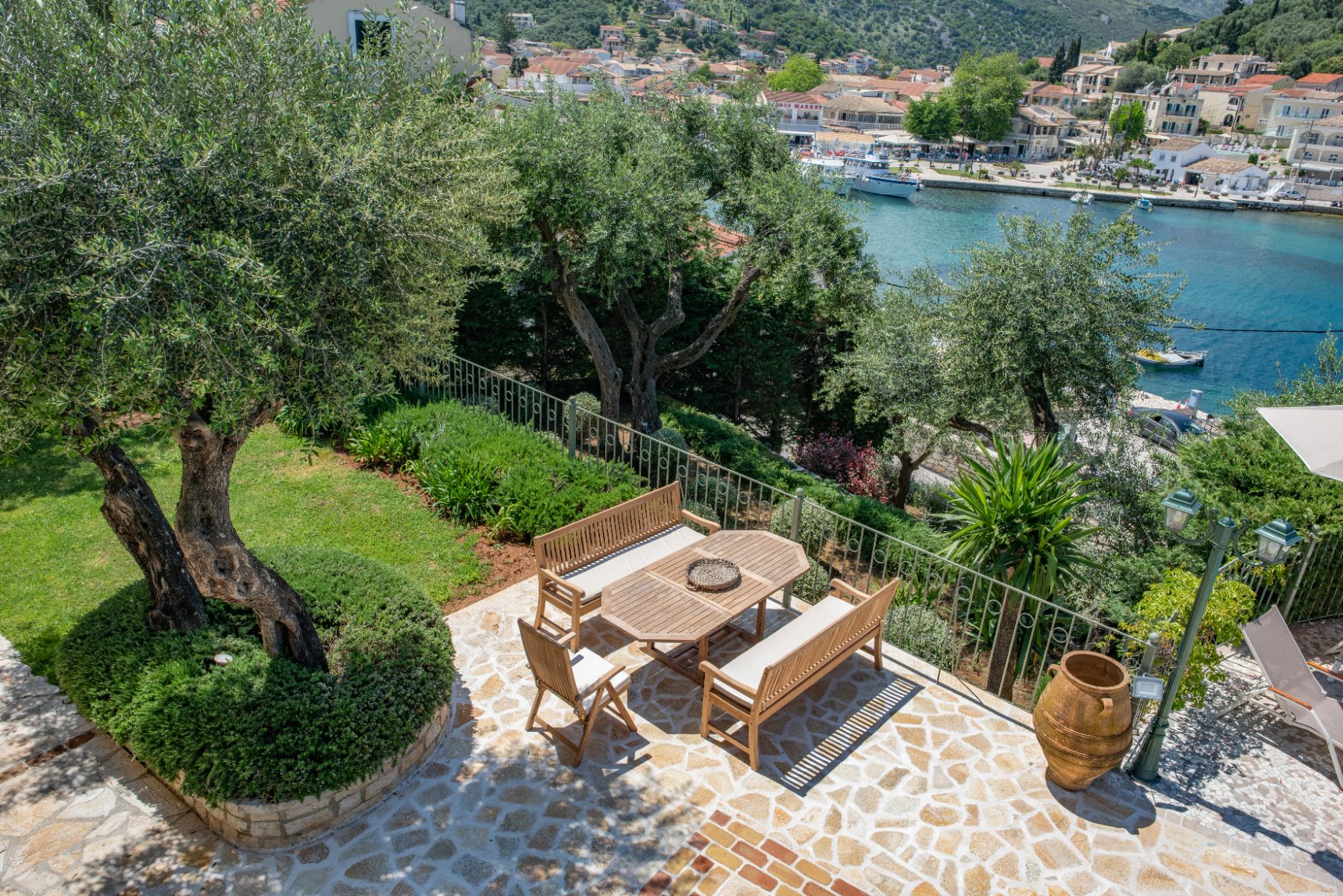 Garden with seating and harbour views at Villa Petra, Corfu