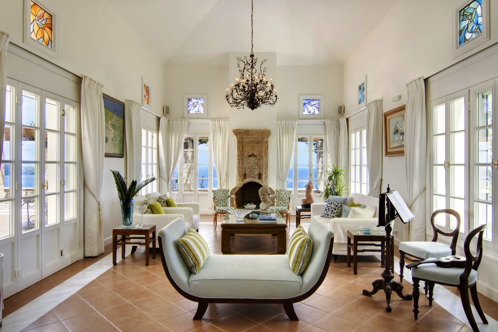 Seating area with occasional furniture, white sofas and green cushions with views over the sea at Villa Selene in Crete
