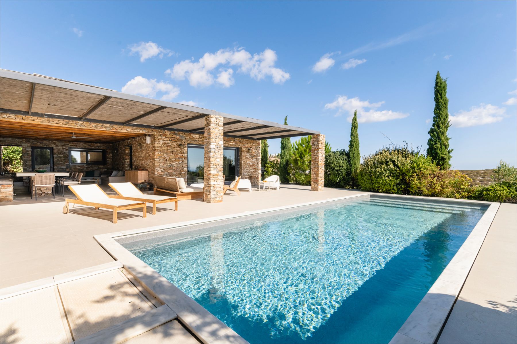 Pool with sun loungers and terrace at Villa Thalia, Sifnos